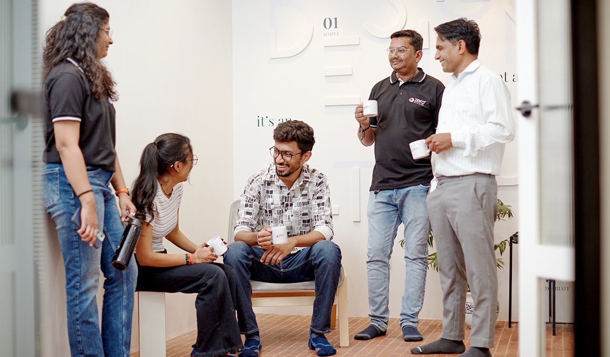 Zero Designs team members interacting in an office space
