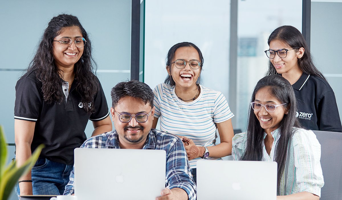 Zero Designs team members interacting in an office space