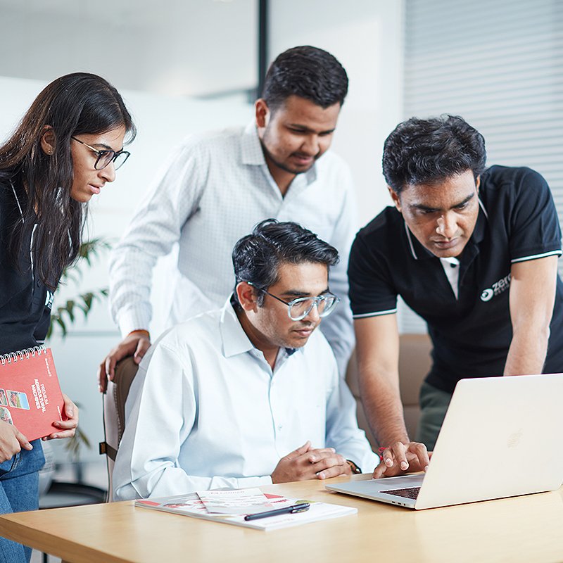 Zero Designs team members interacting in an office space