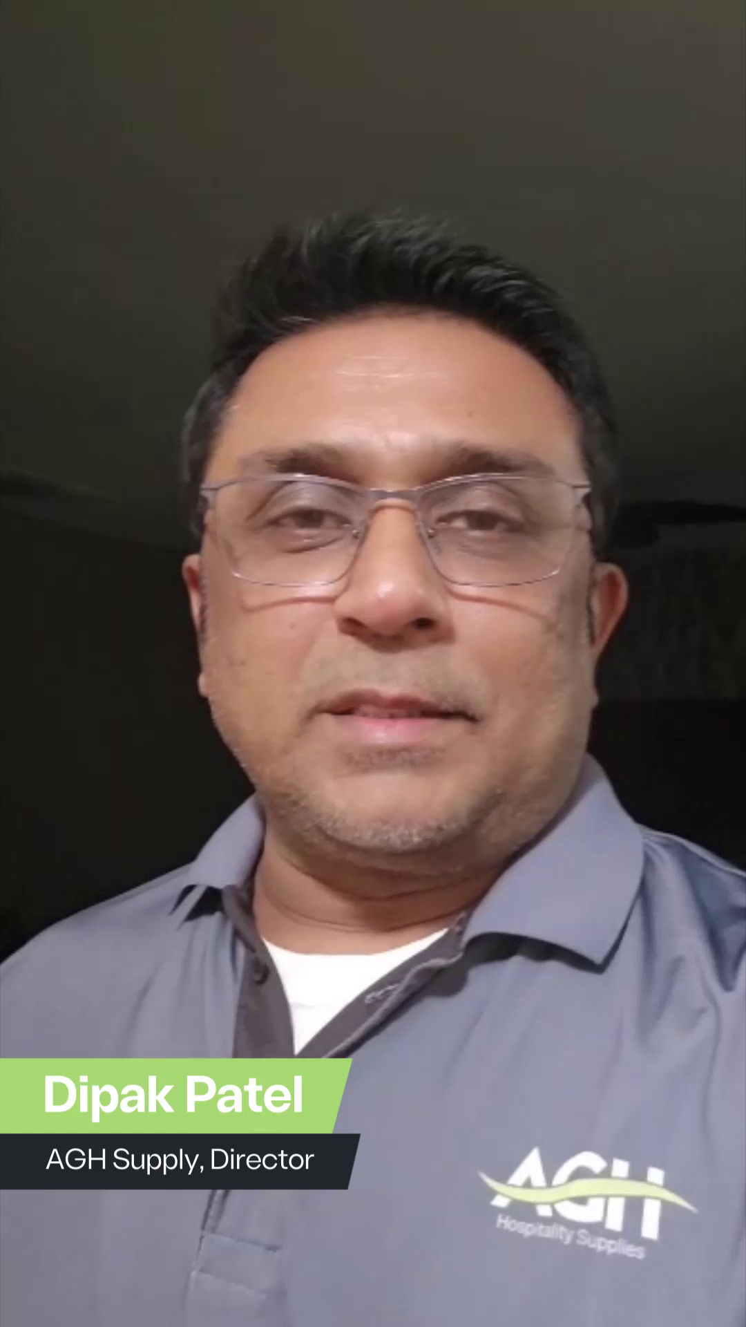 Portrait of Ashraf Engineer, Communication Consultant, smiling in a professional setting with a white background, featuring a text overlay of his name and title in yellow and gray.